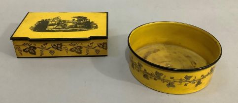 A yellow and black lacquered lidded box, the top having a romantic scene the sides having garlands