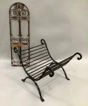 A wrought iron log basket, 37cm x 53cm, together with a wrought iron panelled wall mounted candle