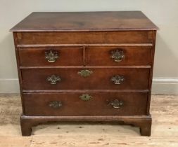 An 18th century oak chest having a deep frieze over two short and two long graduated drawers, on