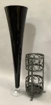 A large floor standing black art glass vase together with a cast metal umbrella stand