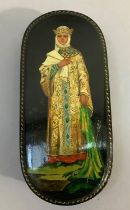 A Russian black lacquered oval lidded box, the lid painted with a woman in gown and crown, 17cm