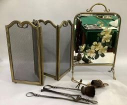 An Edwardian brass framed mirrored fire screen, a four fold mesh fire screen and various fire irons