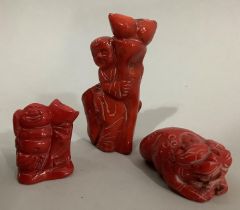 Three pieces of carved and stained coral