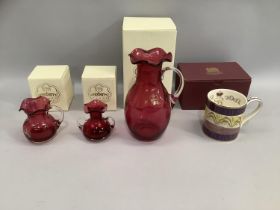 A Royal Scot Cranberry milk jug, another posey vase and a claret jug all boxed, together with a