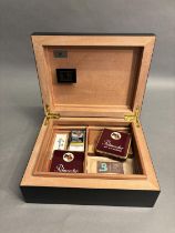 A HUMIDOR BY GERMANUS FOR APPROXIMATELY 50 CIGARS, black ebonised finish with digital hygrometer,