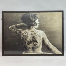 Four black and white photographic prints of historic people with tattoos, largest example