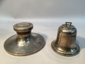 A silver inkwell, circular with reeded rim, monogram to cover, 12cm diameter together with a bell