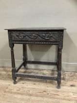 A 19th century oak side table carved border to the surface and frieze drawer, on turned and square