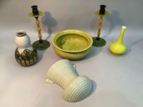 A pair of early 20th century Bakelite candlesticks in shades of green and black, on circular foot,