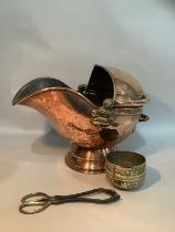 A copper helmet coal scuttle with swing handle, 35cm high, a pair of coal tongs and two Indian