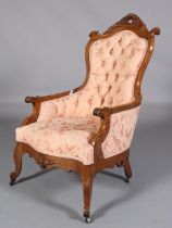 A 19TH CENTURY WALNUT ARMCHAIR, having an encircling frame with pierced and carved foliate