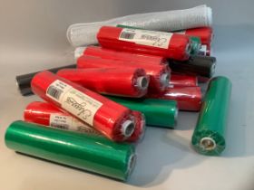 A large quantity of rolls of red and green organza