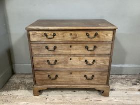 A mahogany chest of four long graduated drawers with cast swing handles and on shaped bracket