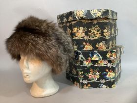 A fox fur winter hat together with two Snelgrove hat boxes