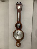 An early 19th century mahogany thermometer/barometer with boxwood stringing, hygrometer, mirrored