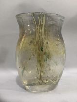 A studio glass vase with lustre thread and fragment inclusions over a gold ground, having a flared