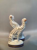 A pair of Sutherland bone china dalmatians in the style of Staffordshire, 19.5 x 17cm