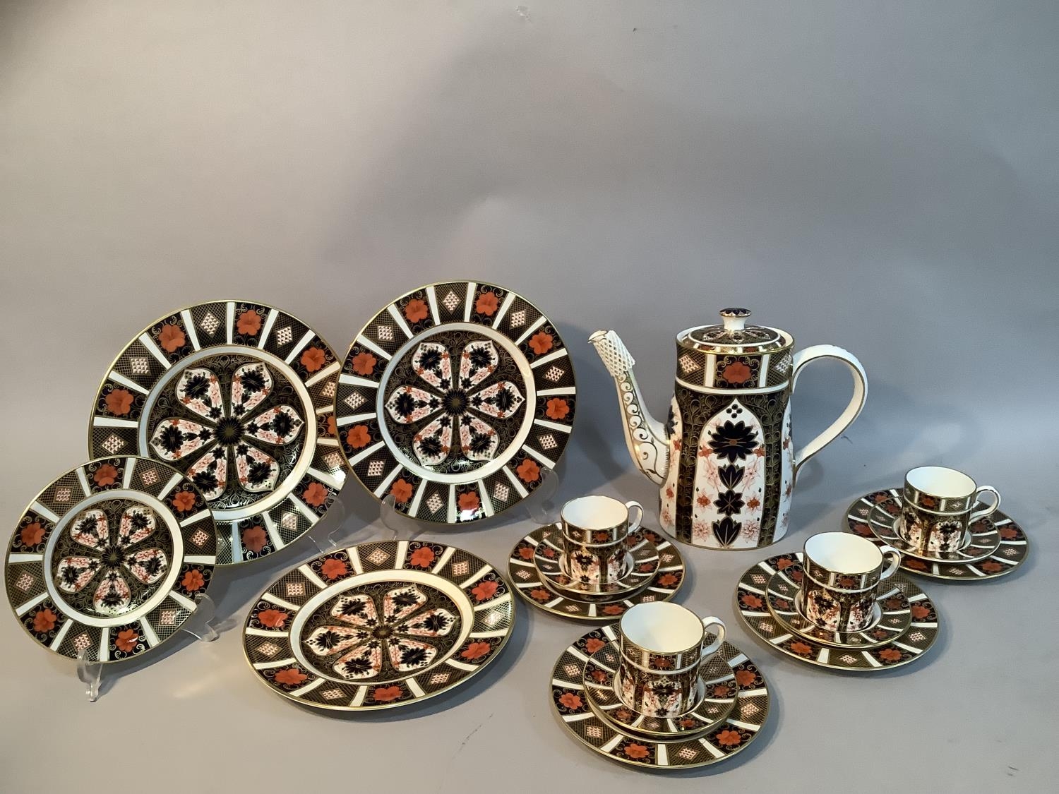 A Royal Crown Derby Old Imari pattern no.1128 coffee service comprising a coffee pot, four coffee