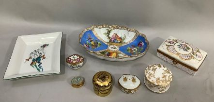 A Meissen dish painted with scenes of figures within panels of blue and white together with