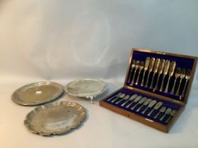 Three silver plate on copper trays, one with gadroon rim, the other etched and another on three