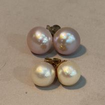 Two pairs of cultured pearl ear studs, one pair 8mm on 9ct gold posts and scrolls, one pair 10mm