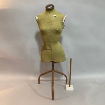 A vintage Singer's tailors dummy on metal stand together with a hem measure