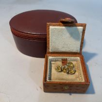 An ostrich leather stud box by Garrard with cream felt interior, approximately 7.5cm x 7cm x 3.5cm