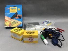 Two chorded glue guns with glue gun accessories