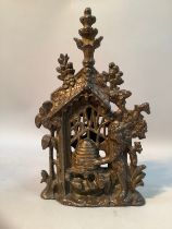 A late Victorian cast iron money box modelled as a bear and bee hive