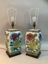 A pair of Chinese ceramic table lamps, of square tapered body, enamelled with chrysanthemums in