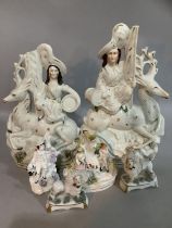 Two Staffordshire figures of a Scottish man and woman with stags, (A/F) two small spill vases, two