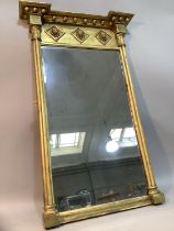 An early 19th century style gilded wall mirror, the frieze moulded in high relief with three lion