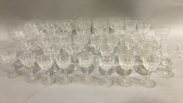 A suite of 20th century etched glasses comprising coupes, wines etc. together with further glass
