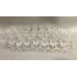 A suite of 20th century etched glasses comprising coupes, wines etc. together with further glass
