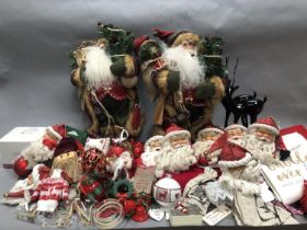 Two figures of Santa as an explorer with skis, lamps and sacks together with Christmas tea towels,