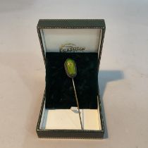 A Victorian scarab beetle stick pin, the iridescent carapace collet set in silver with a base