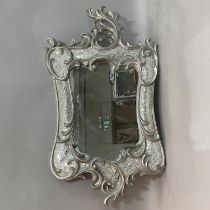 Two silvered wall mirrors, being heavily moulded with an outer frame of 'c' scrolls and inner mosaic
