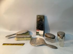 An Edward VII silver six piece dressing table set, consisting of a hair brushes, a clothes brush,