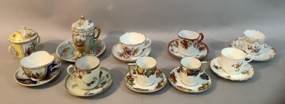 A collection of continental porcelain cabinet cups and saucers, comprising Meissen cup and cover