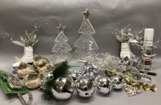 A collection of Christmas decorations including silver baubles, lighted garlands, table