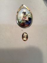 A 19th century ceramic portrait of a female collet set in an oval base metal brooch mount together
