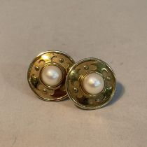 A pair of cultured pearl ear studs in 9ct gold each set with a 7mm pearl raised against textured and