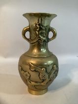 A Japanese brass vase with twin handles to the neck, decorated in relief with prunus blossom, 9cm