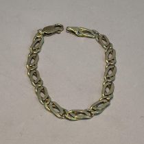 A bracelet in rolled double curb links of yellow metal (tests as 14ct gold) with a later 9ct gold