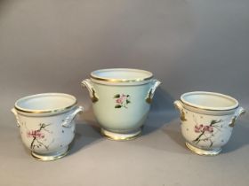 A pair of Vista Allegra cache pots with painted floral decoration and another larger example