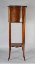 An Edward VII mahogany and satinwood strung jardiniere stand
