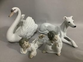A porcelain blanc de chine figure of a reclining greyhound together with a Lladro model of a swan
