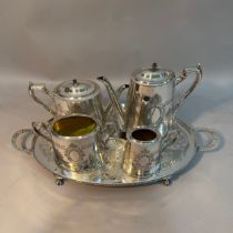 Silver plate on copper coffee service with etched decoration and a twin handled tray on paw feet