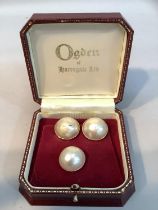 A pair of Mabé pearl ear clips(at fault) in 18ct gold by Ogdens of Harrogate, in original box