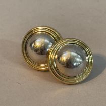 A pair of ear studs in 18ct yellow and white gold, each a white gold dome within a concentric yellow